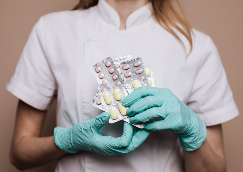 doctor holding medicine with gloves