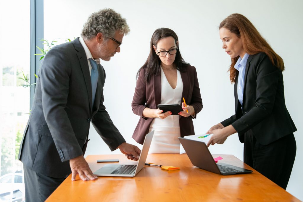 people dressed in suits meeting in an office